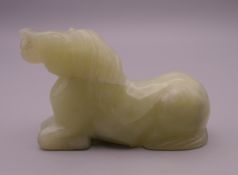 A Chinese pale green jade horse. 7.5 cm long.