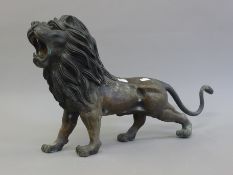 A bronze model of a lion. 55 cm long.