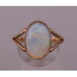 A 9 ct gold opal ring. Ring size S/T. 3.4 grammes total weight.