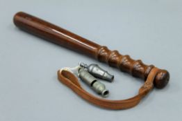 A rosewood police truncheon, stamped M.P and Crown, a Metropolitan whistle and a pewter whistle.