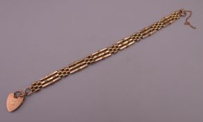 A Victorian 9 ct gold three-bar gate bracelet. 18.5 cm long. 13.2 grammes.