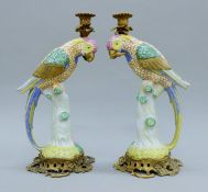 A pair of gilt metal mounted porcelain parrot form candlesticks. 41 cm high.