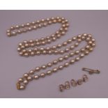 A faux pearl necklace and a quantity of various studs. The necklace 144 cm long.