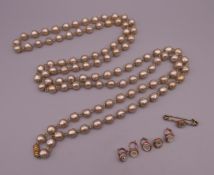 A faux pearl necklace and a quantity of various studs. The necklace 144 cm long.