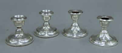 A pair of silver candlesticks London 1916 and a similar pair Chester 1908.