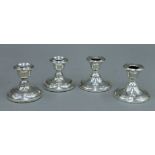 A pair of silver candlesticks London 1916 and a similar pair Chester 1908.