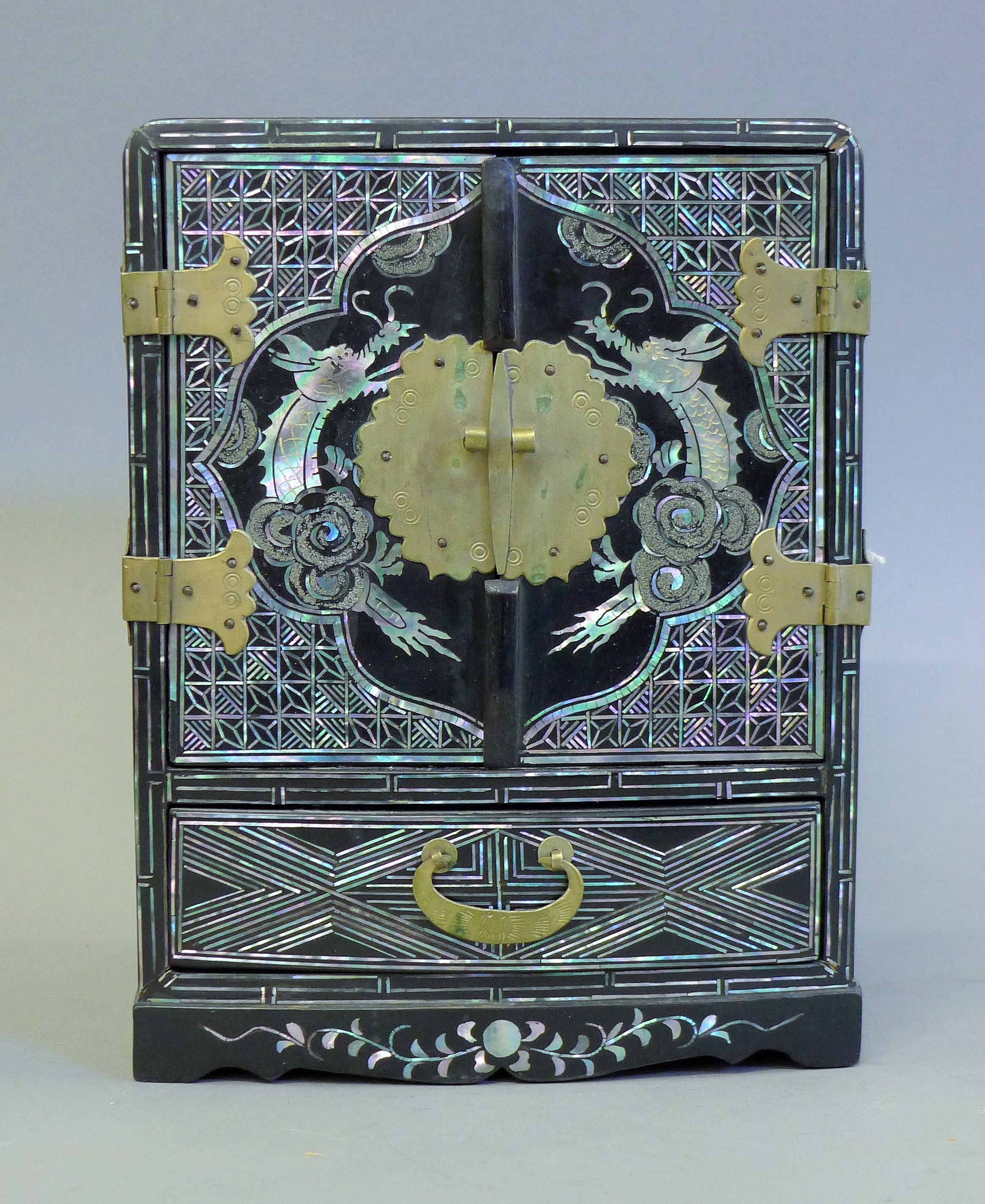 A Korean lacquered and mother-of-pearl jewellery box. 21 cm high.
