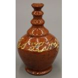 A 19th century slip ware pottery money box. 17 cm high.