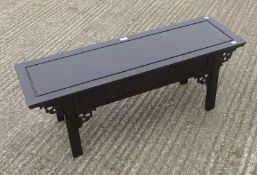 A Chinese carved wooden bench. 110 cm long.