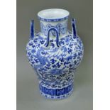 A Chinese blue and white porcelain four handled vase. 38 cm high.