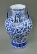 A Chinese blue and white porcelain four handled vase. 38 cm high.