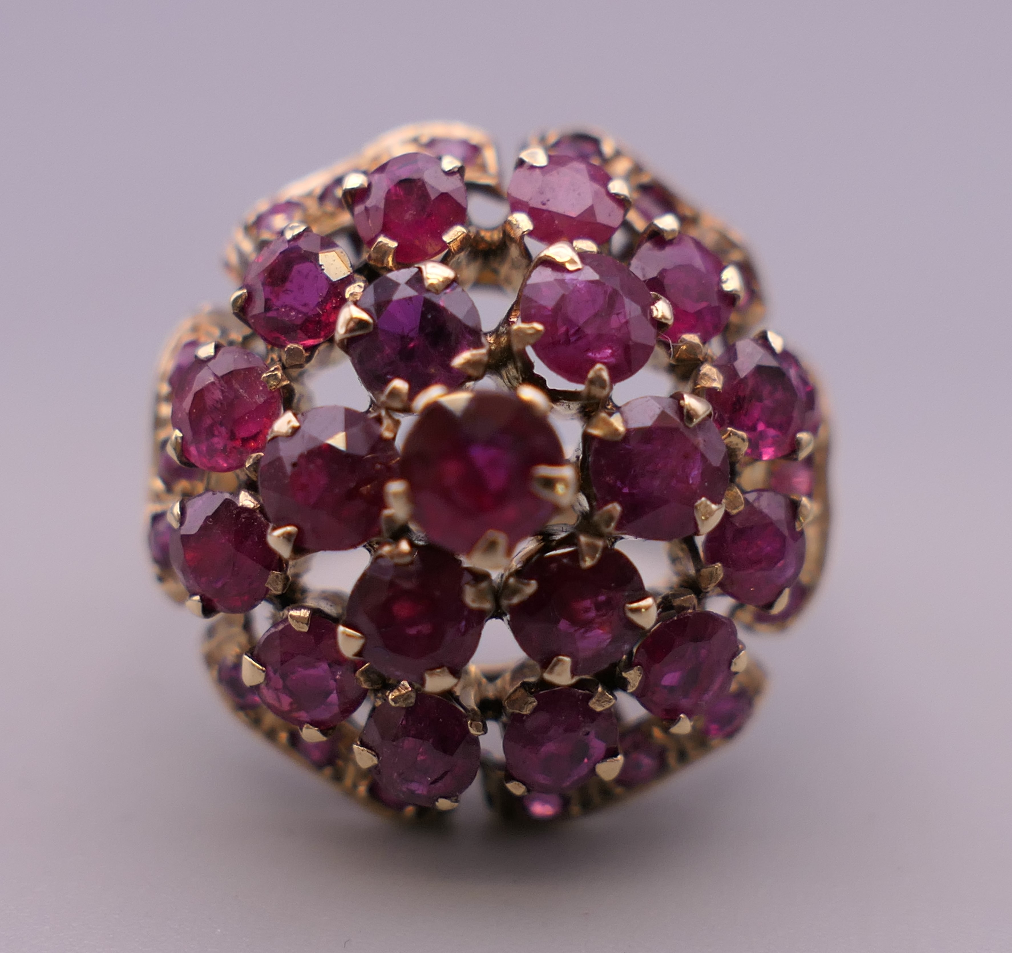 A 14 ct gold ruby cocktail ring. Ring size K/L. 5.6 grammes total weight.