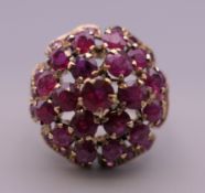 A 14 ct gold ruby cocktail ring. Ring size K/L. 5.6 grammes total weight.