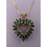A 14 K gold emerald heart pendant on chain. The pendant 2.5 cm high. 3.9 grammes total weight.