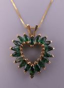 A 14 K gold emerald heart pendant on chain. The pendant 2.5 cm high. 3.9 grammes total weight.