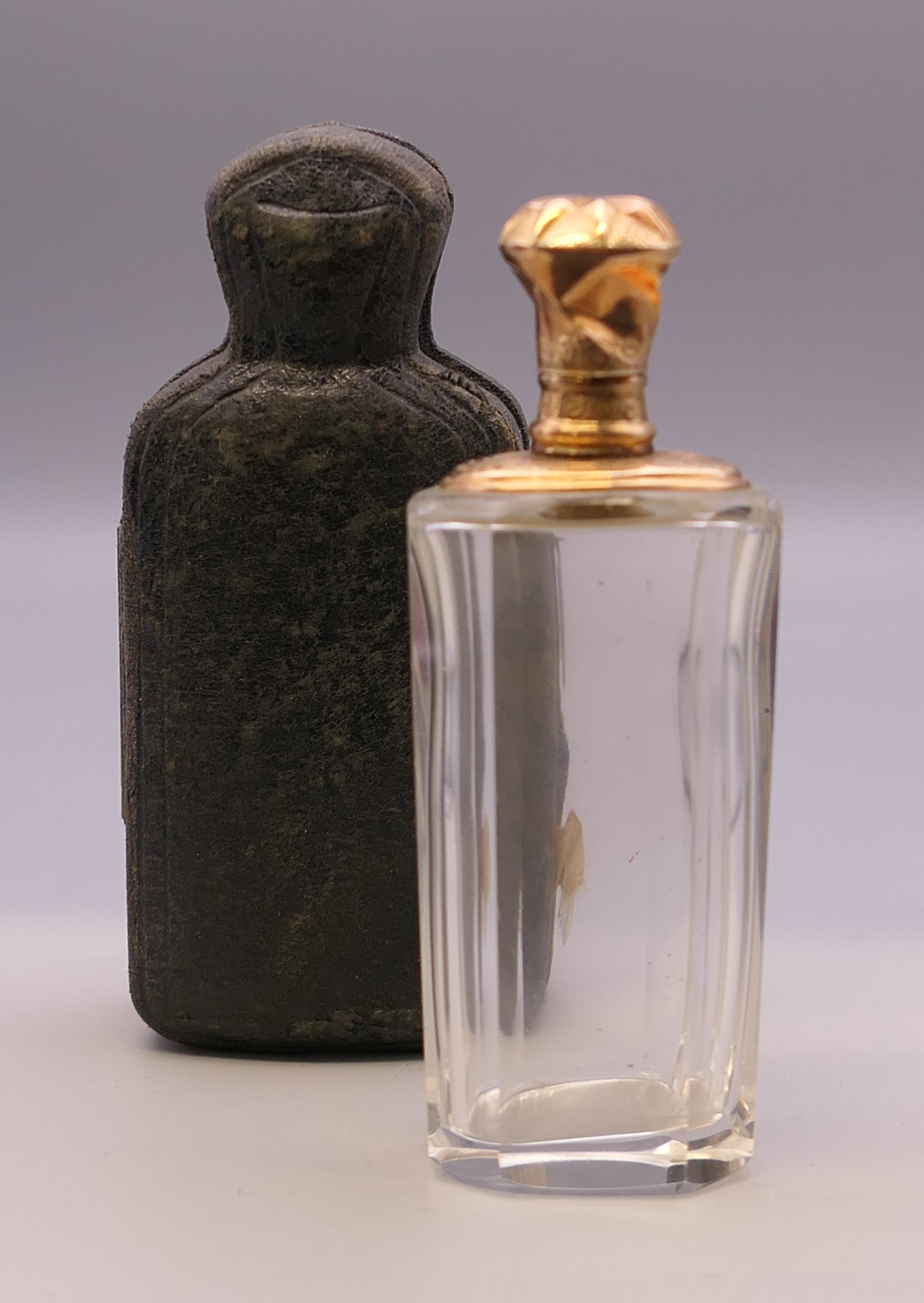 A cased Continental unmarked gold topped glass scent bottle. 9.5 cm high overall.