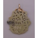 A gold mounted pierced jade pendant. 7.5 cm high.