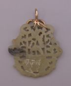 A gold mounted pierced jade pendant. 7.5 cm high.