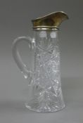 A silver top cut glass jug. 26.5 cm high.