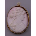 An unmarked gold mounted cameo brooch/pendant. 4.5 cm high.