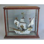 A late 19th/early 20th century model of a galleon in a glass lift up case. The case 70 cm wide.