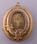 A Victorian unmarked locket. 3 cm high.