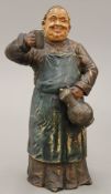 A 19th century painted terracotta model of a jolly monk. 26 cm high.