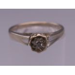 A 9 ct white gold diamond solitaire ring. Ring size N. 2 grammes total weight.