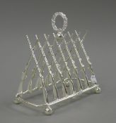 A silver plated rifle form toast rack. 20 cm long.