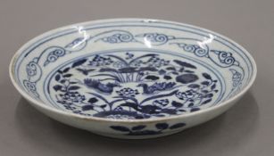 A Chinese blue and white porcelain shallow dish decorated with ducks, etc.