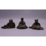 Three Japanese patinated lead figures. The largest 3.5 cm high.