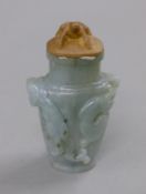 A small jade vase with wooden top surmounted with a frog. 10.5 cm high.