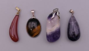 Four mineral specimen pendants. The largest 4.5 cm high.