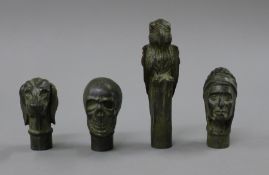 Four bronze walking stick tops.