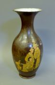 A Chinese brown ground porcelain vase decorated with gold figures. 39 cm high.