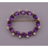 A 14 ct gold amethyst and pearl brooch. 4 cm wide. 8.1 grammes total weight.
