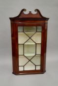 A 19th century glazed mahogany corner cabinet. 67 cm wide.