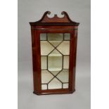 A 19th century glazed mahogany corner cabinet. 67 cm wide.