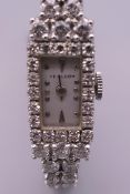 A 14 ct white gold ladies diamond set cocktail watch. 1 cm wide. 24.7 grammes total weight.