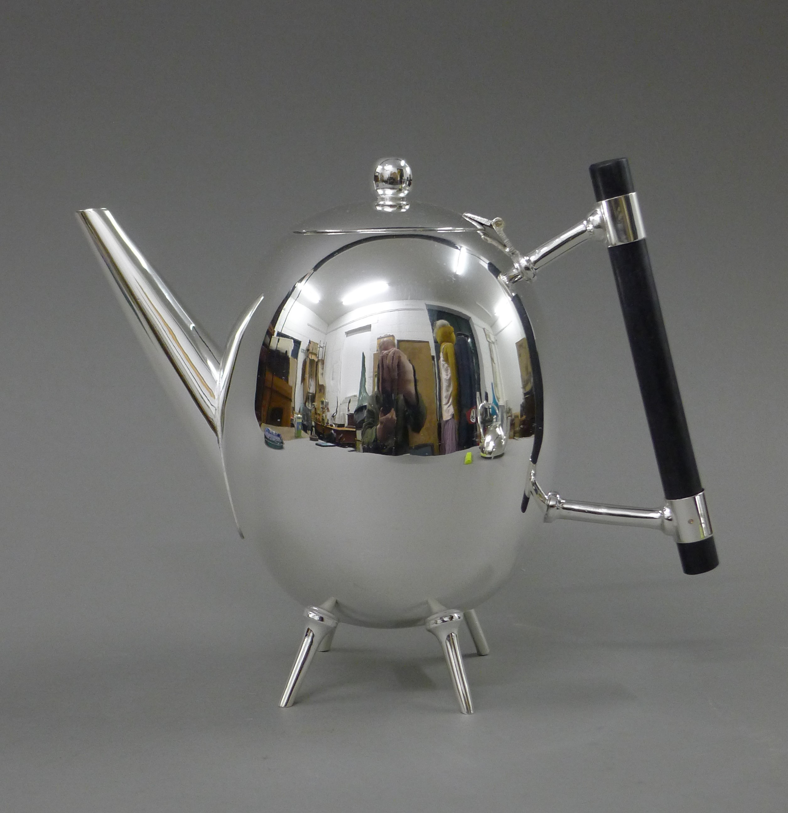 A Christopher Dresser style teapot. 18 cm high.