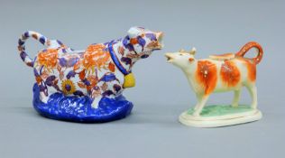 Two porcelain cow creamers. The largest 13.5 cm high.