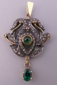 A diamond and emerald set pendant. 3.5 cm high.