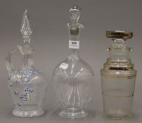 Three various glass decanters. The largest 30 cm high.