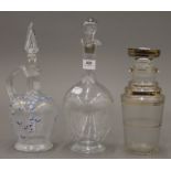 Three various glass decanters. The largest 30 cm high.