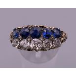 An 18 ct gold diamond and sapphire two row ring. Ring size X. 6.6 grammes total weight.