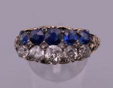 An 18 ct gold diamond and sapphire two row ring. Ring size X. 6.6 grammes total weight.