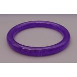 A lavender jade bangle. 6 cm inner diameter.