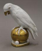 A German gilt decorated ceramic parrot. 20 cm high.