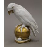 A German gilt decorated ceramic parrot. 20 cm high.