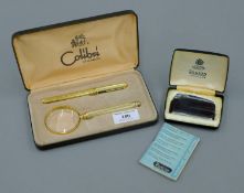 A cased Calibri pen and magnifying glass, and a cased Ronson lighter.